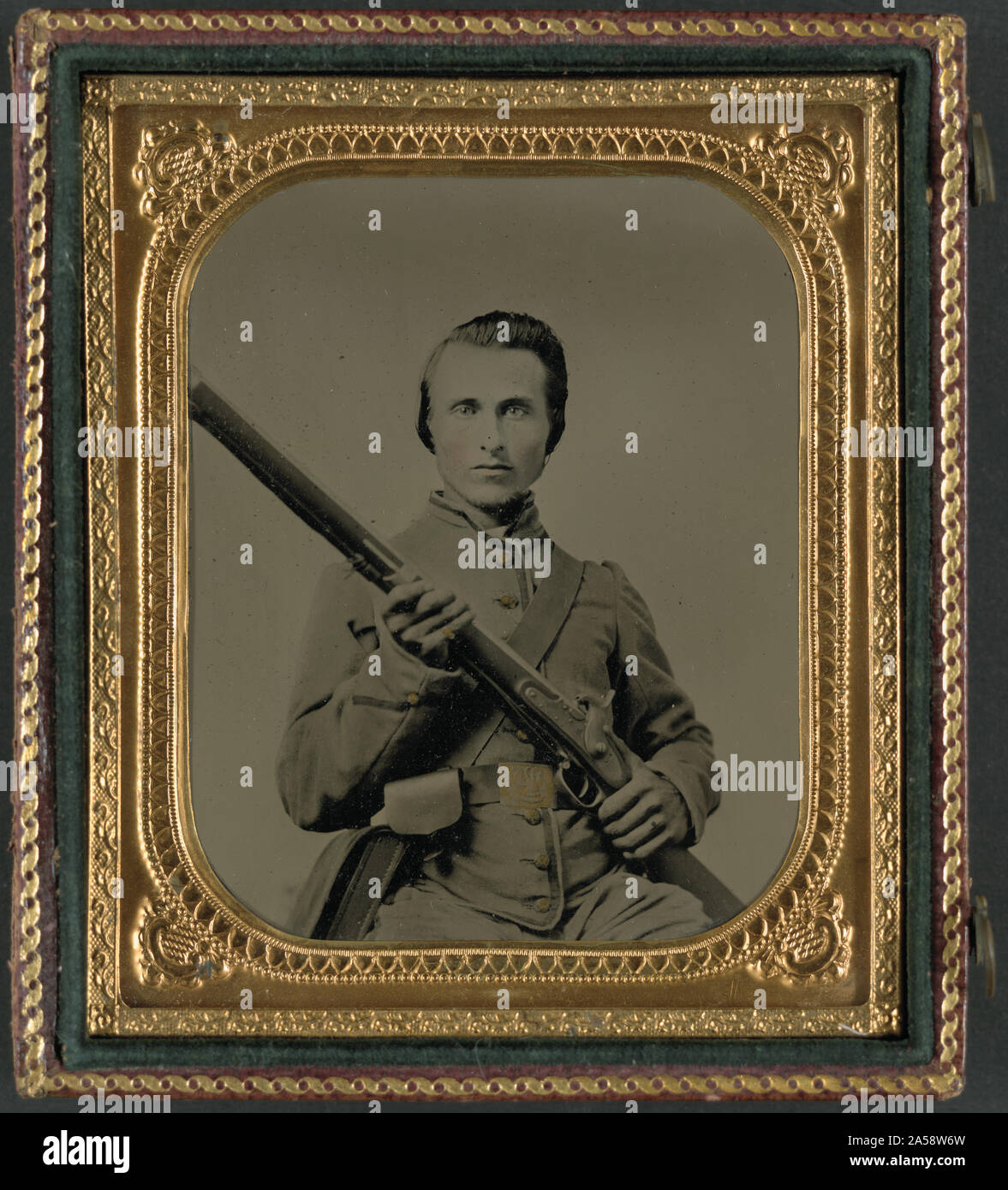 Unidentified soldier in Confederate uniform and Louisiana state seal belt buckle with musket Stock Photo