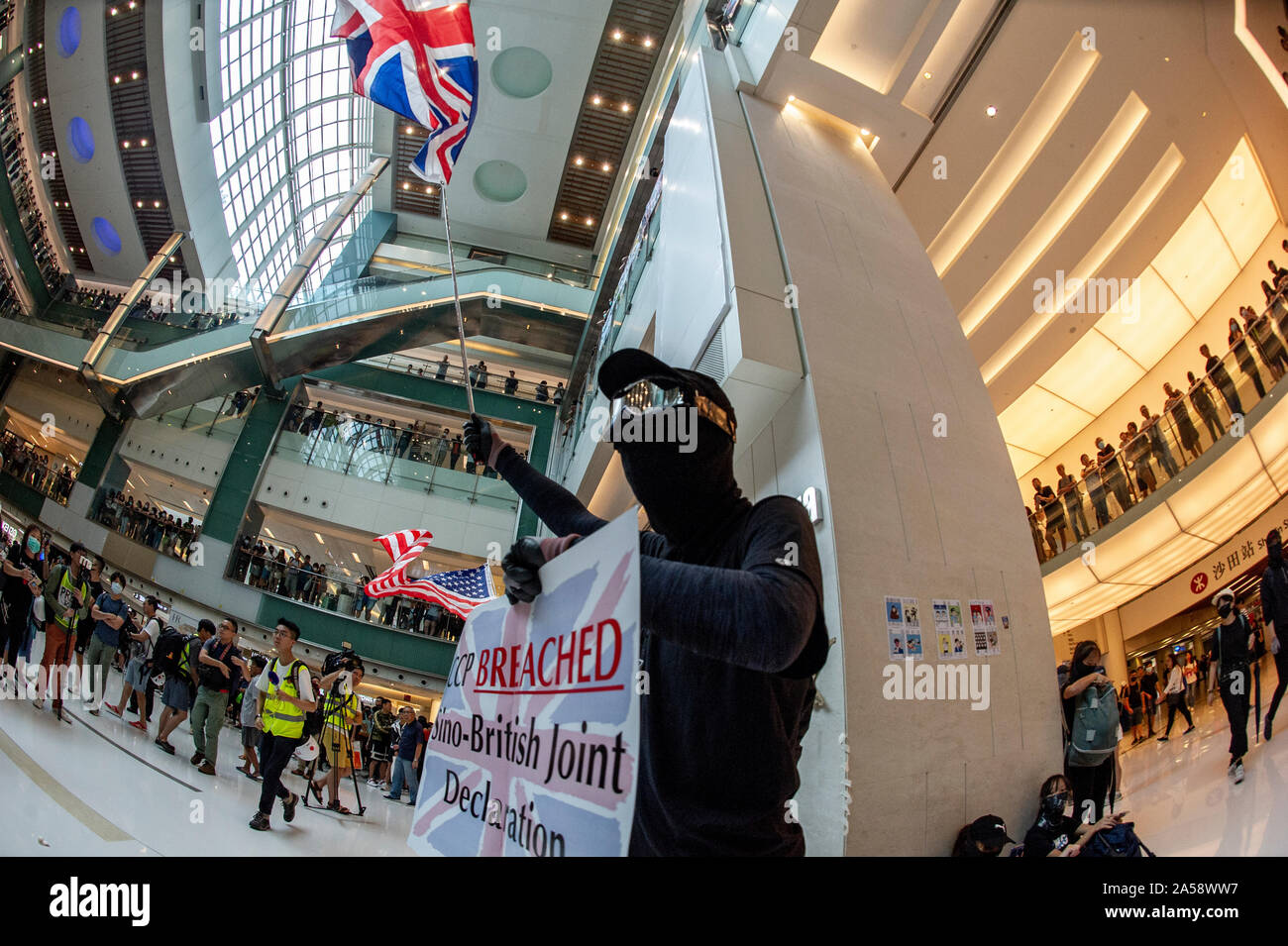 Hong Kong protestors wave British and American flags in protest in a shopping mall in Hong Kong before violence erupts Stock Photo