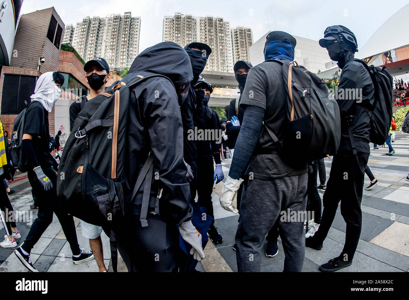 Gangs of protestors in Hong Kong gather in the late afternoon in anticipation of an evening of disruption Stock Photo