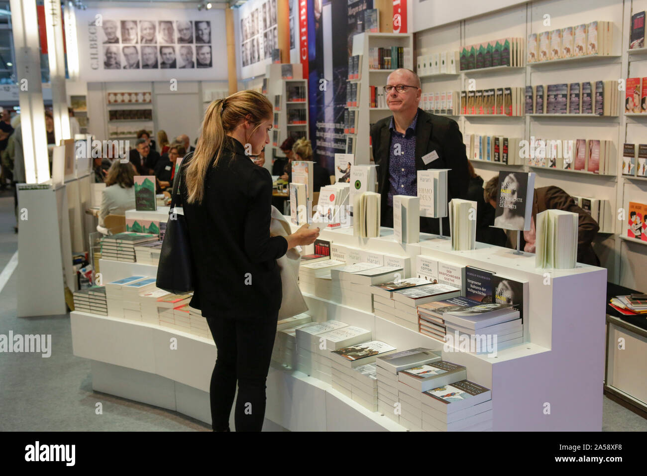 Frankfurt, Germany. 18th Oct, 2019. A woman looks at books at the booth of the German publisher C. H. Beck. The 71th Frankfurt Book Fair 2019 is the world largest book fair with over 7,500 exhibitors and over 285,000 expected visitors. The Guest of Honour for the 2019 fair is Norway. (Photo by Michael Debets/Pacific Press) Credit: Pacific Press Agency/Alamy Live News Stock Photo