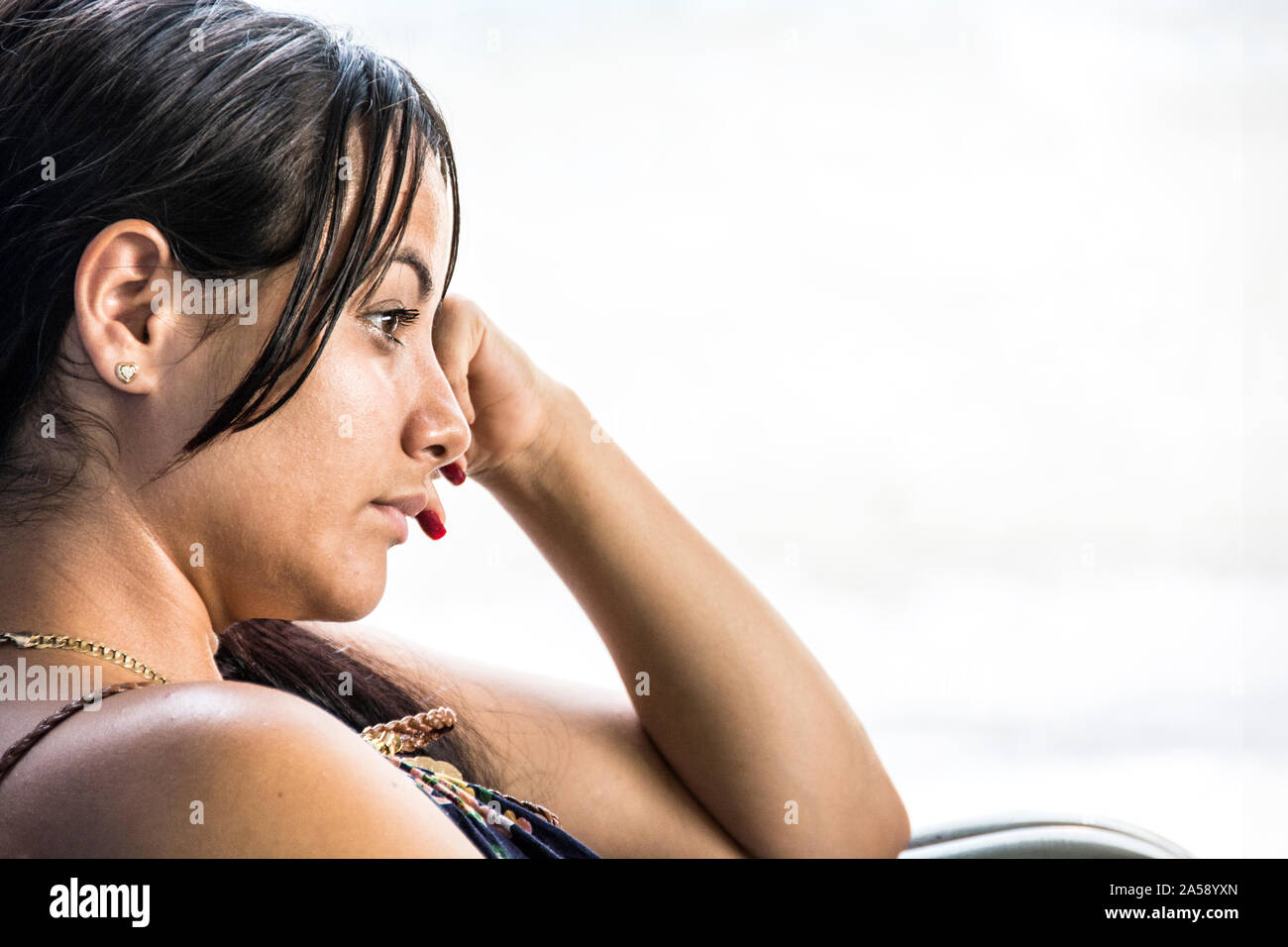 A young, Cuban woman, aged 25, contemplating her life. Stock Photo