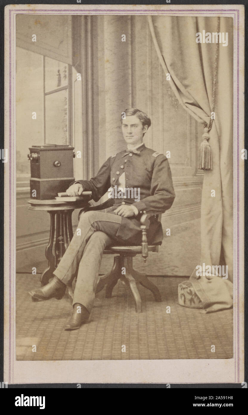 Unidentified soldier in uniform with cabinet stereograph viewer] / H. B. Hillyer's Art Rooms, Austin, Texas Stock Photo