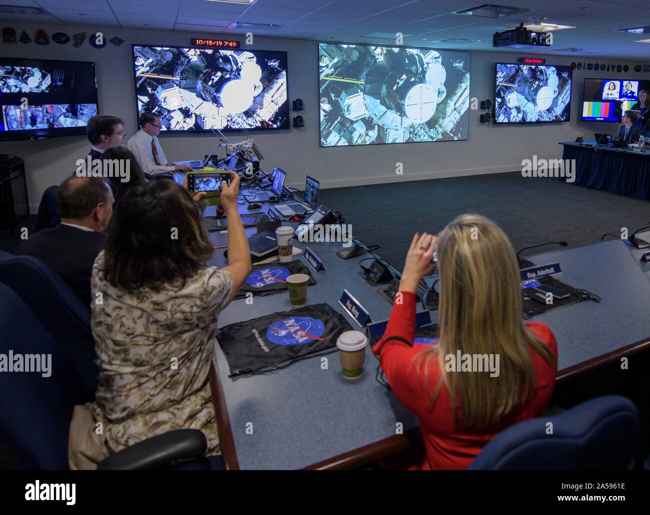 Washington, United States of America. 18 October, 2019. U.S. Rep. Kendra Horn, left, and Rep. Grace Meng, right, watch NASA astronauts Christina Koch and Jessica Meir during the first all-woman spacewalk from the Space Operations Center October 18, 2019 in Washington, DC. Credit: Joel Kowsky/NASA/Alamy Live News Stock Photo