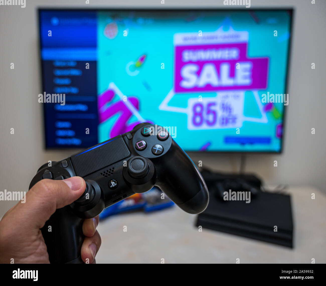 Summer sale in PS4 play store. Pre-order, download, play Sony Play Station 4 Pro game on the big LCD screen at home. Stock Photo