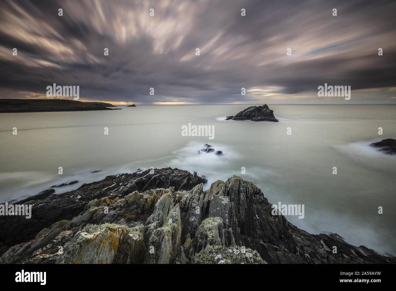 Gloomy scenery of the calm ocean under the dark sky  in Pentire Point East, Cornwall, UK Stock Photo