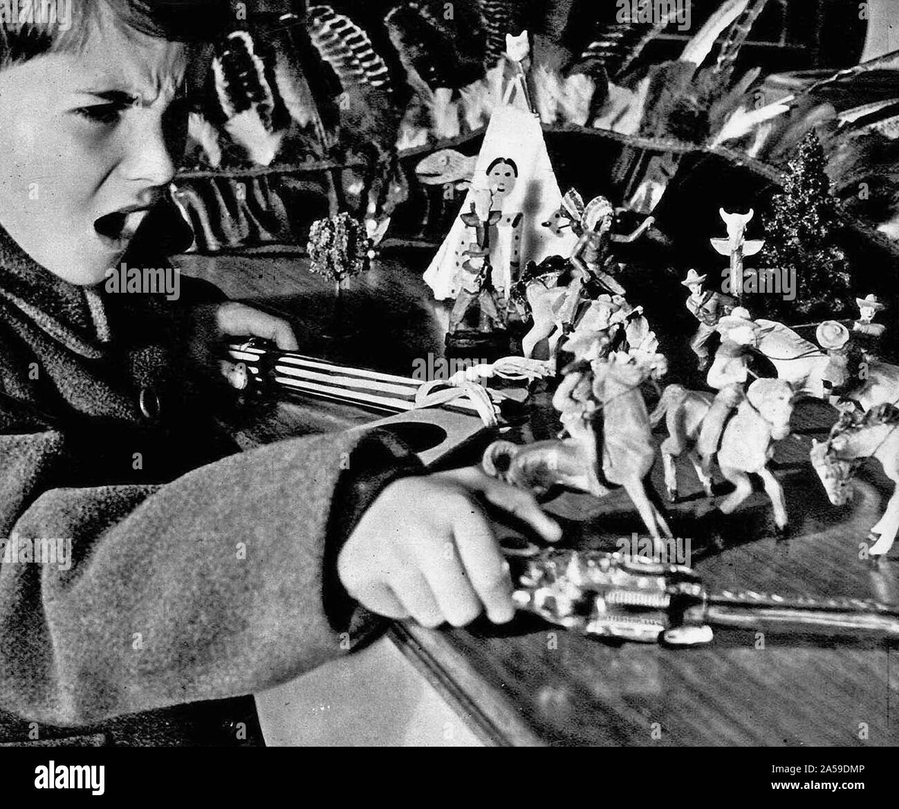 1951 child playing with tin soldiers Stock Photo