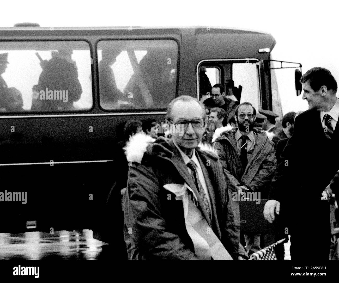 1981 - Former hostages Robert C. Ode and Donald Cooke, left to right, wearing winter coats, arrive at the base for their departure to the United States.  The 52 hostages were hospitalized for a few days after their release from Iran. Stock Photo