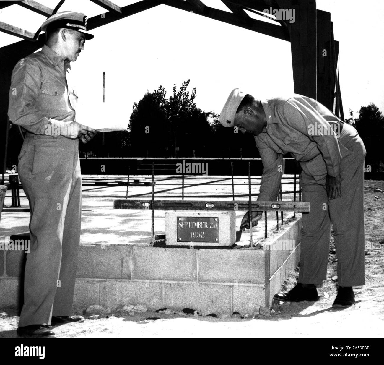 Cornerstone laying ceremony of the new Depot Chapel at the Barstow Annex of the Marine Corps Depot of Supplies, San Francisco, on 2 September 1952.  The service was conducted by US Navy Chaplain Warren L. Bost (Left), Protestant Chaplain at the Barstow Annex, with US Marine Colonel Arthur J. Davis, Commanding Officer of the Barstow Annex setting the cornerstone in place. Stock Photo