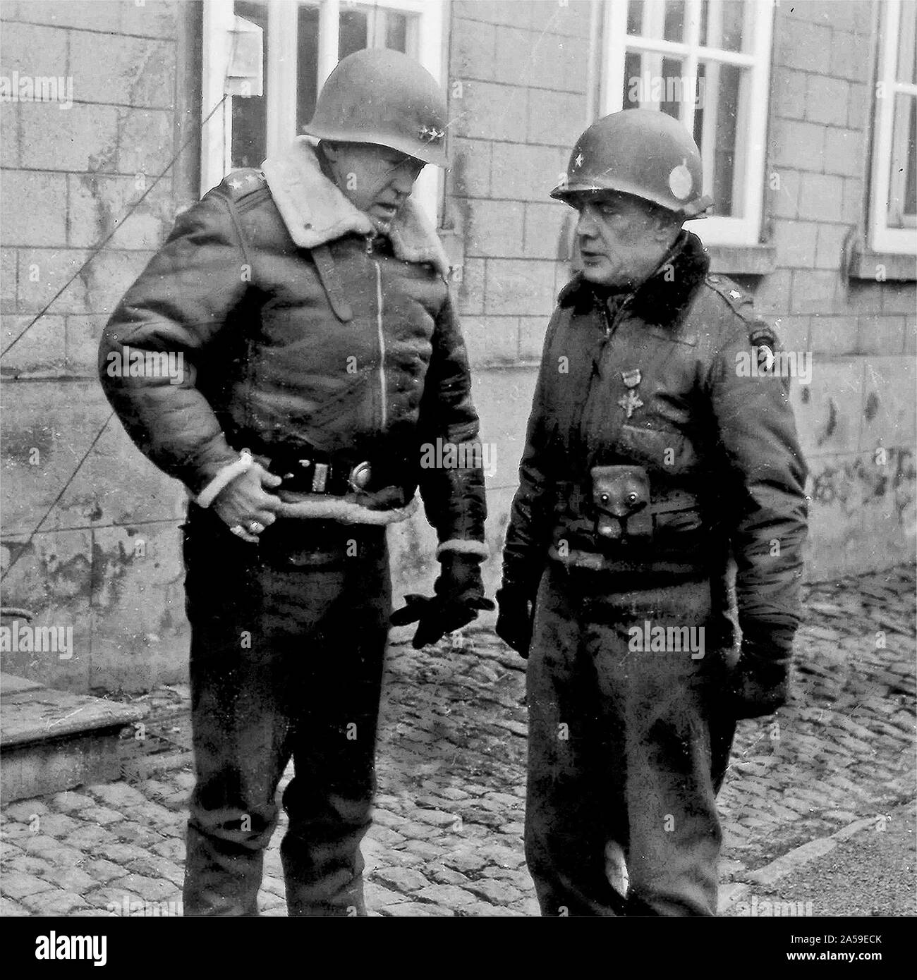 Lt. Gen. George S. Patton speaks to Brig. Gen. Anthony McAuliffe, January 1945. Patton led the Third Army in a sweep across France and an instrumental role in defeating the German counter offensive in the Ardennes. Patton commanded the Third Army from 1944 to 1945. Third Army’s unit motto “Patton’s Own – Third, Always First” is in honor of Patton. Stock Photo