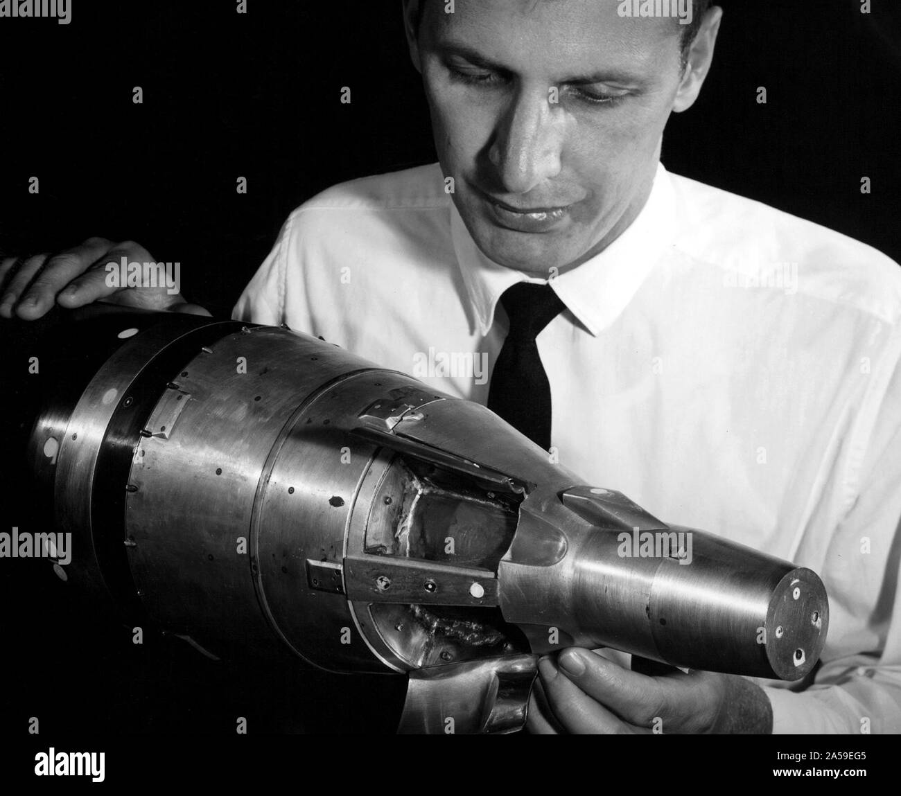 A researcher at the National Aeronautics and Space Administration (NASA) Lewis Research Center examines a small-scale model of the Gemini capsule in the 10- by 10-Foot Supersonic Wind Tunnel test section. Stock Photo