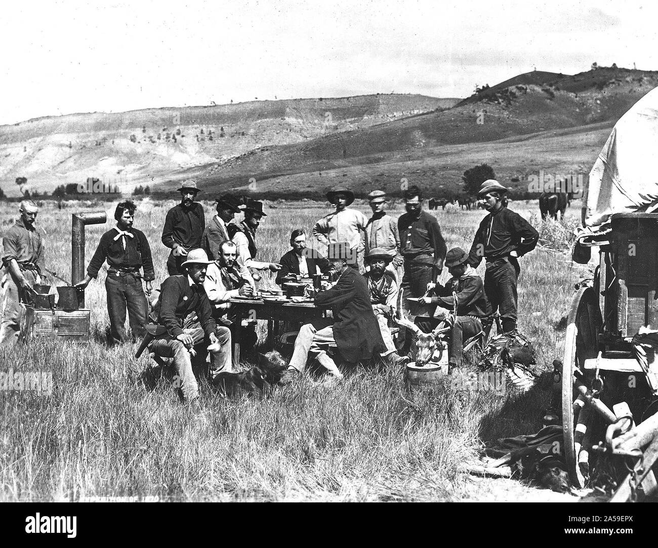 Standing left to right: John 'Potato John' Raymond and 'Val,' cooks; Sanford R. Gifford, landscape painter; Henry W. Elliott, artist; James Stevenson, assistant; H.D. Schmidt, naturalist; E. Campbell Carrington, zoologist; L.A. Bartlett, general assistant; William Henry Jackson, photographer. Sitting left to right: C.S. Turnbull, secretary; J.H. Beaman, meteorologist; Ferdinand.V. Hayden, geologist in charge; Cyrus Thomas, agriculturist; Raphael, hunter; A.L. Ford, mineralogist. U.S. Geological and Geographical Survey of the Territories (Hayden Survey). Stock Photo