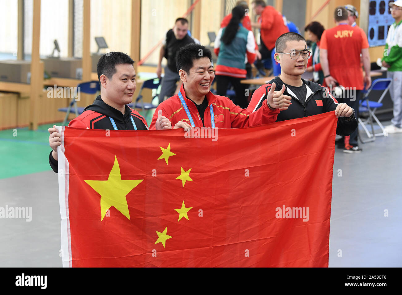 Wuhan, China's Hubei Province. 19th Oct, 2019. Jin Yongde (C), Xie Zhenxiang (L) and Yao Zhaonan of China celebrate after winning the team competition of the Men's 25m Military Rapid Fire Pistol of the 7th CISM Military World Games in Wuhan, capital of central China's Hubei Province, Oct. 19, 2019. Credit: Wan Xiang/Xinhua/Alamy Live News Stock Photo