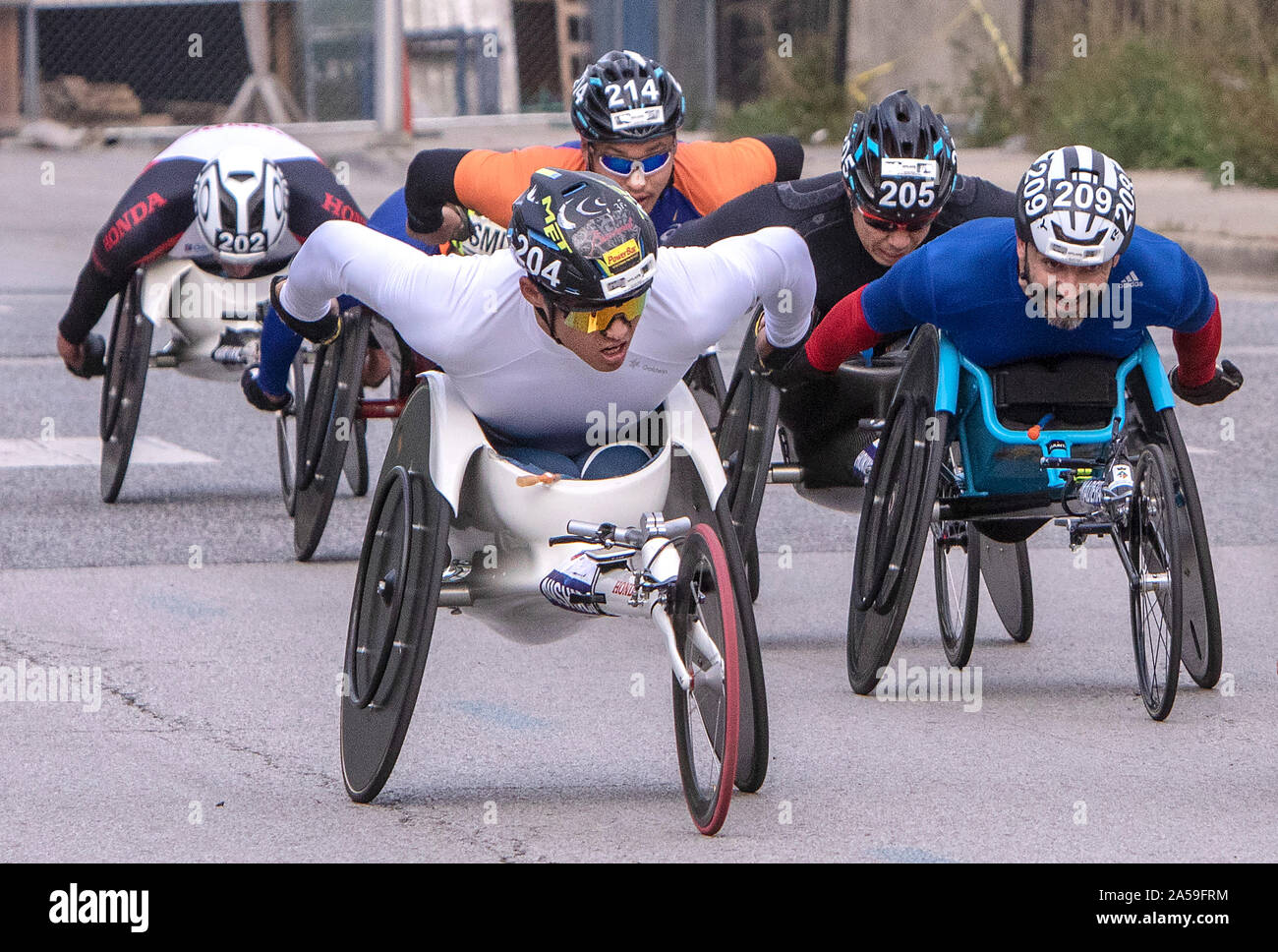 Japanese Paralympians Nishida Hiroki #204, Kota Hokinoue, #205, Aaron Pike USA #206, Jorge Madera #209 from Spain,  race towards the finish line. The Stock Photo