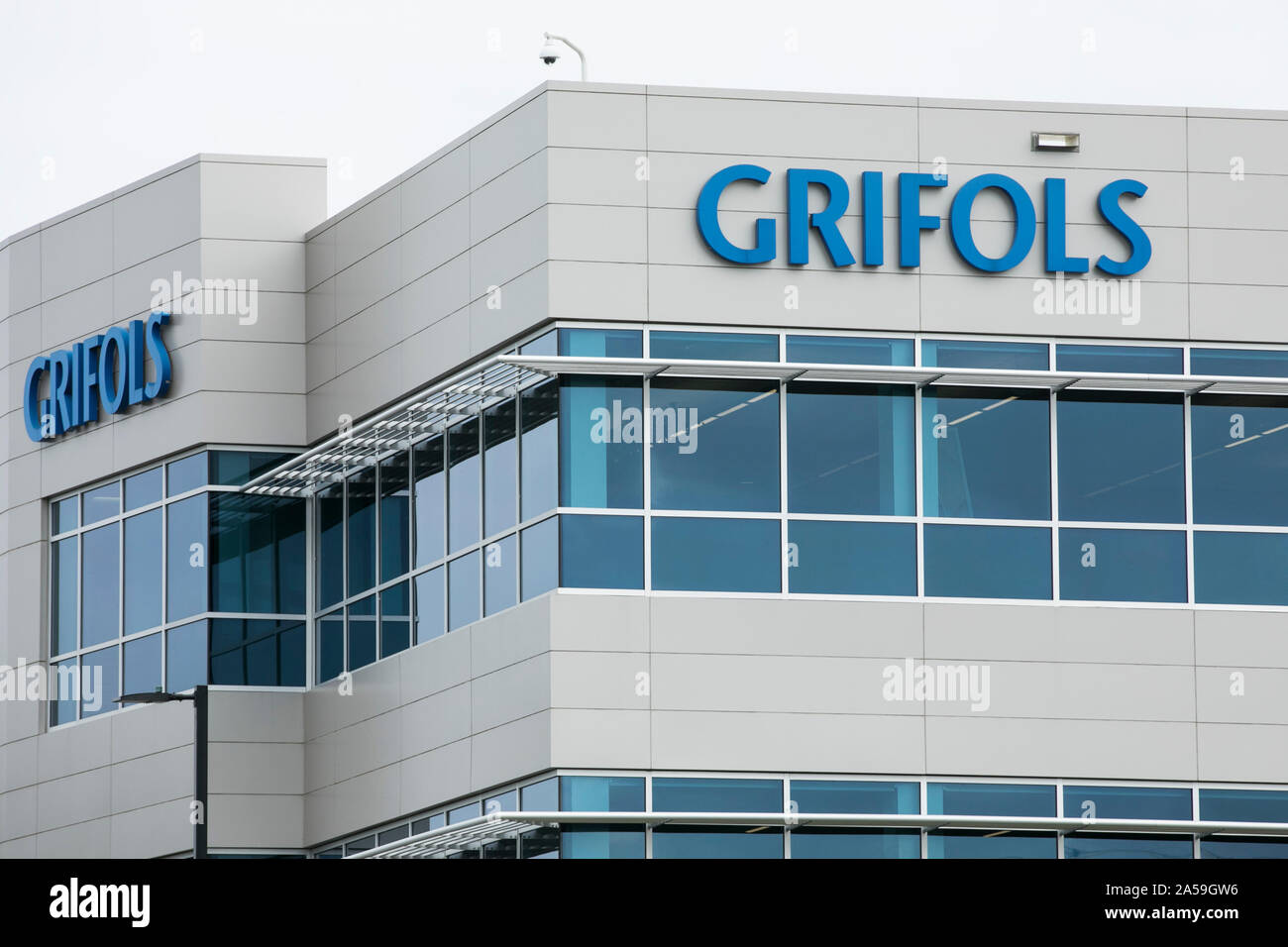 A logo sign outside of a facility occupied by Grifols in Clayton, North