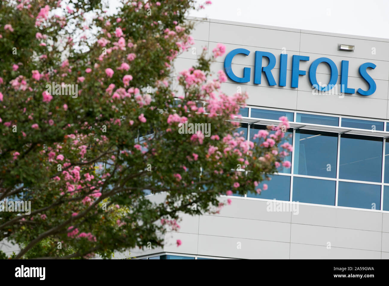 A logo sign outside of a facility occupied by Grifols in Clayton, North