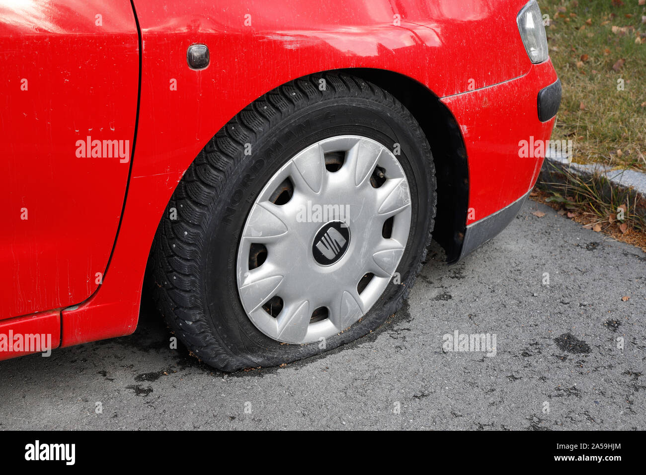 Klabu, Norway - October 10, 2019: View of a flat front wheel on red Seat car. Stock Photo