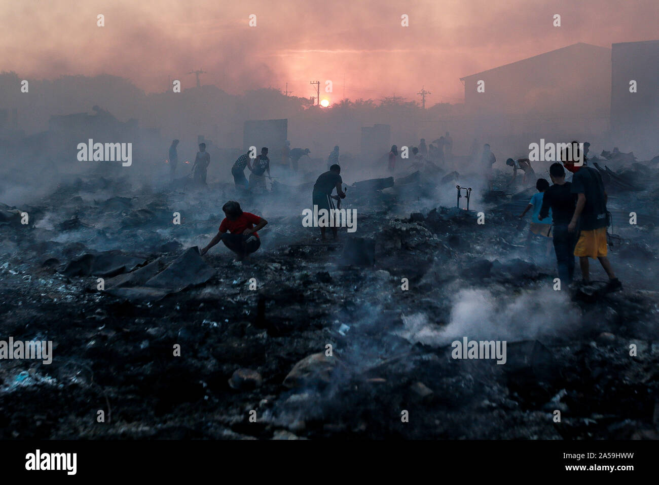 Beijing, Philippines. 18th Oct, 2019. Residents look for their belongings through their charred homes after a fire at a residential area in Navotas City, the Philippines, Oct. 18, 2019. According to the Navotas City Disaster Risk Reduction Management Office, around 200 shanties were razed in the fire. Credit: Rouelle Umali/Xinhua/Alamy Live News Stock Photo