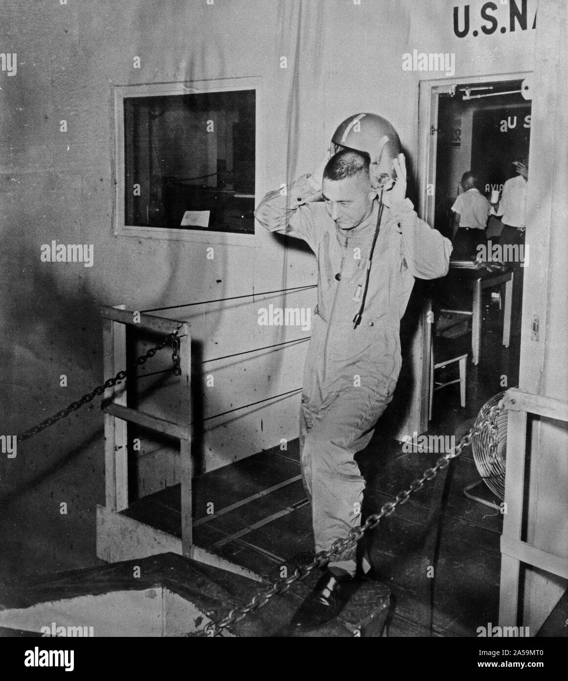 (1959) --- Astronaut Virgil (Gus) Grissom is pictured leaving a U.S. Navy installation and removing his helmet. Stock Photo