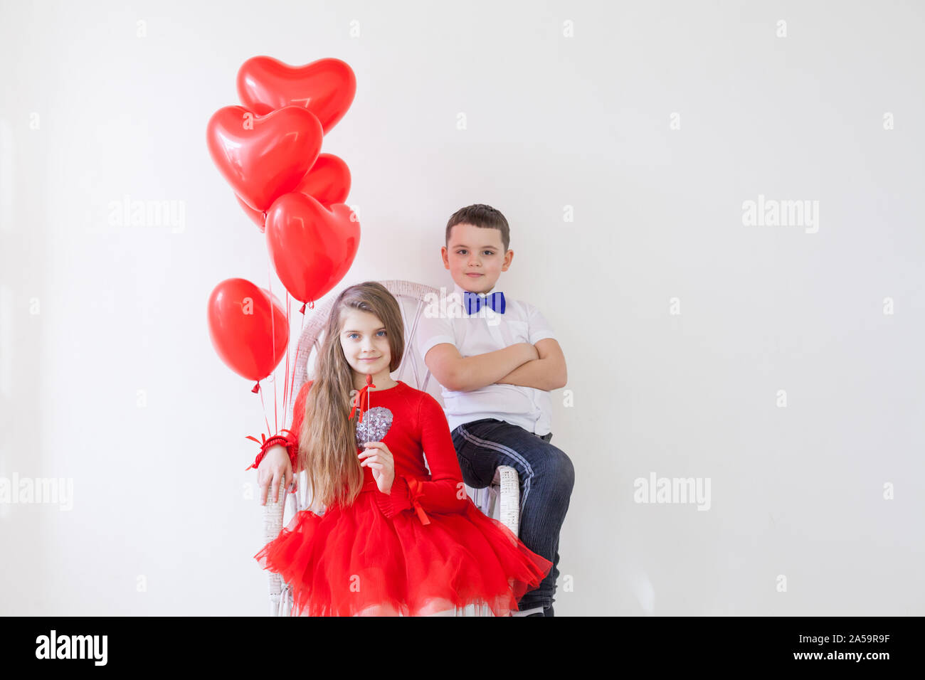 Girl and boy with balloons on Valentine's Day Stock Photo Alamy
