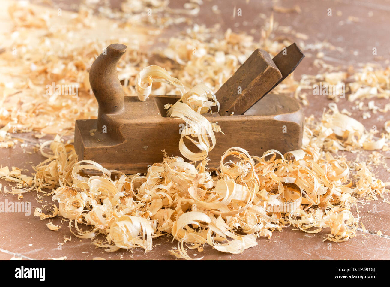 Old wooden hand plane for woodworking with wood shavings Stock Photo
