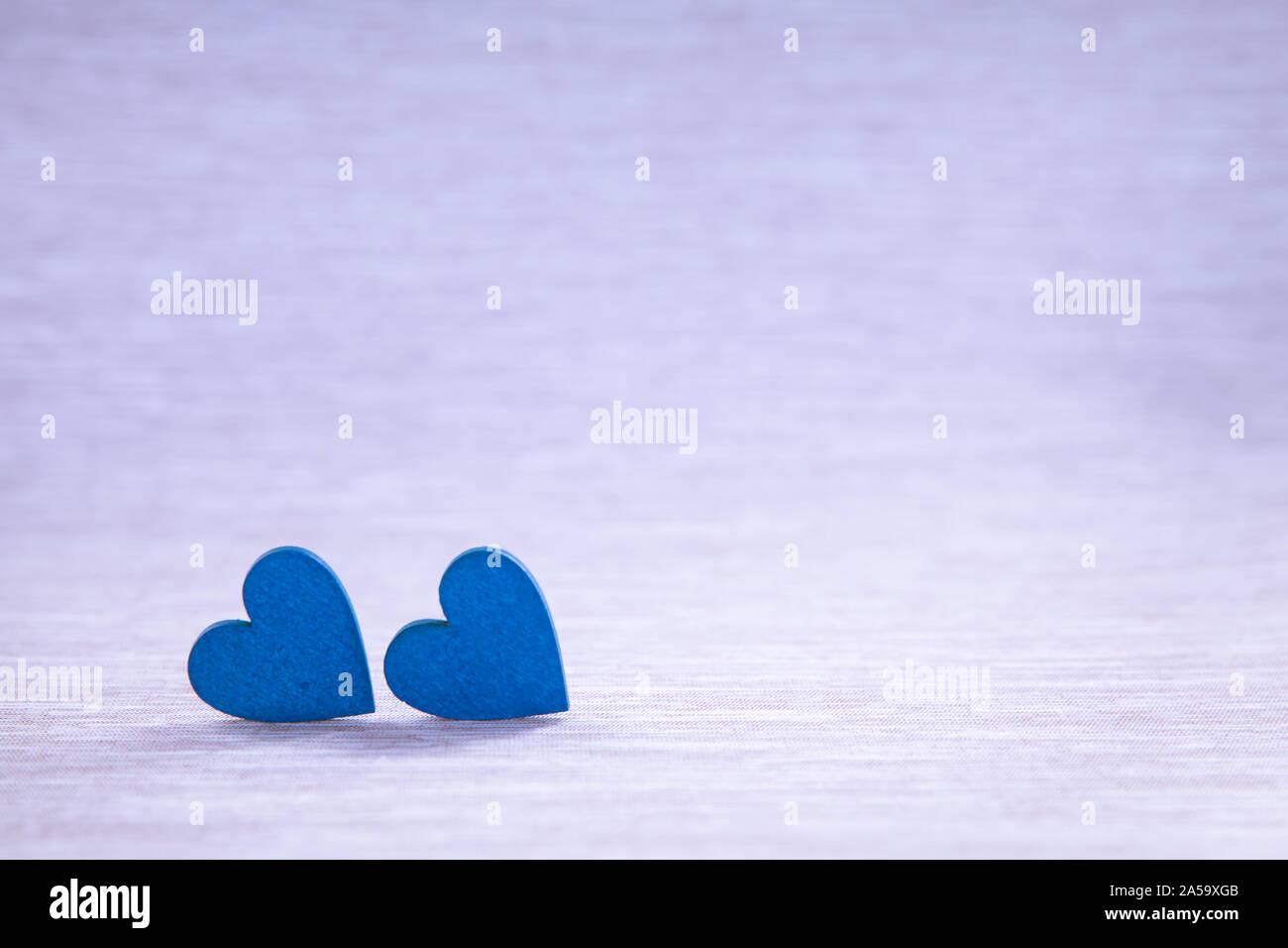 Wooden hearts on beautiful background. Two hearts, background for greetings on Valentine's Day. Blue hearts. Stock Photo