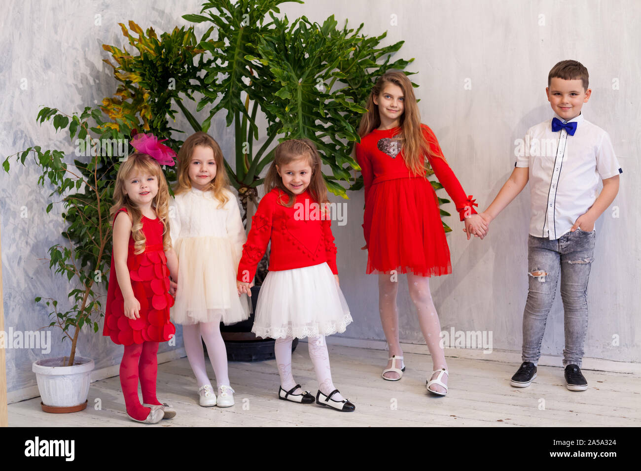 four girls in a white room by green plants Stock Photo Alamy
