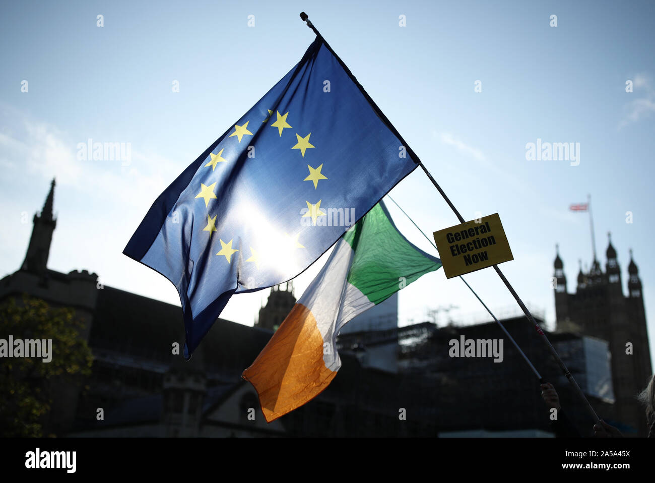 A ean Union and an Irish flag fly outside the Houses of Parliament in London ahead of Prime Minister Boris Johnson delivering a statement in the House of Commons on his new Brexit deal after the EU Council summit, on what has been dubbed 'Super Saturday'. Stock Photo