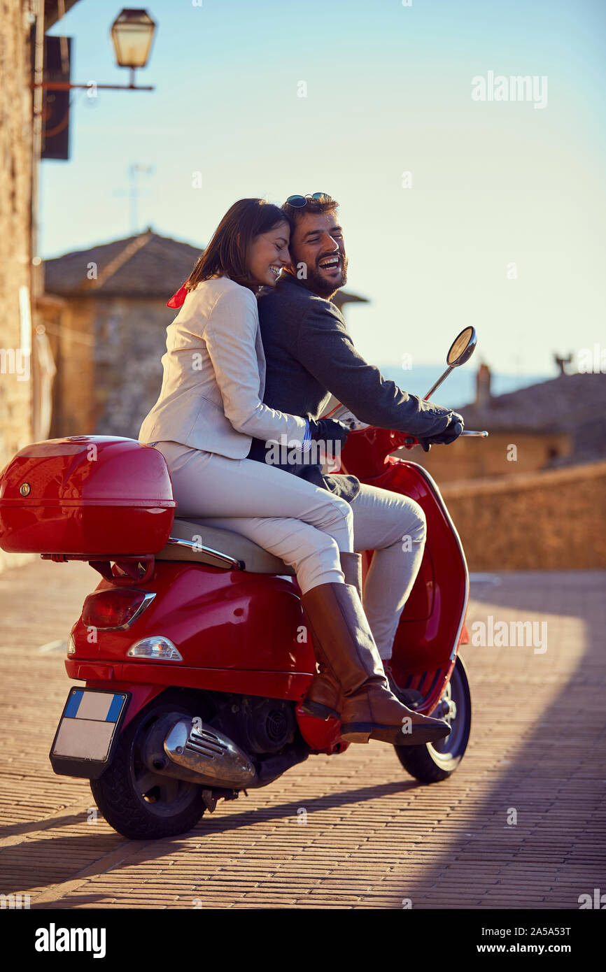 Couple riding motor scooter in hi-res stock photography and images - Alamy