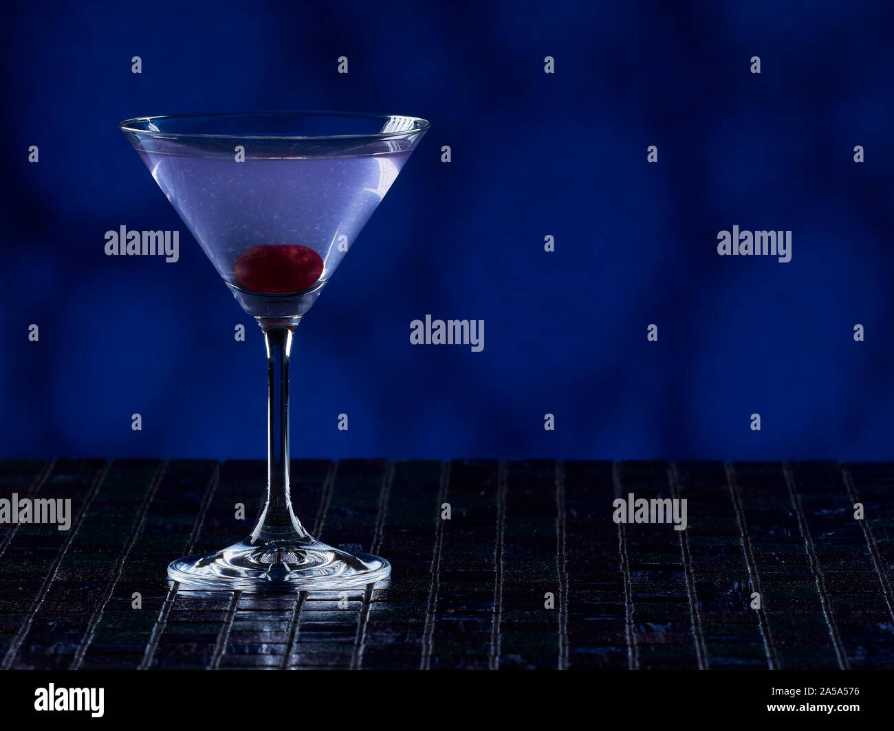 Aviation cocktail on blue background, copy space on the right side Stock Photo