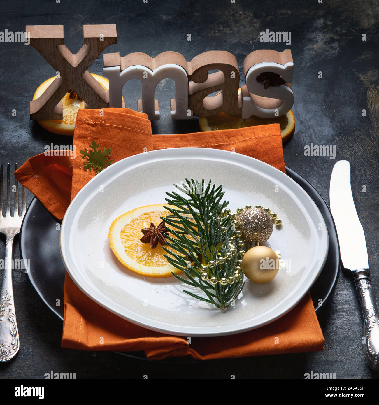 Christmas table setting. Holiday Decorations on black background. Stock Photo