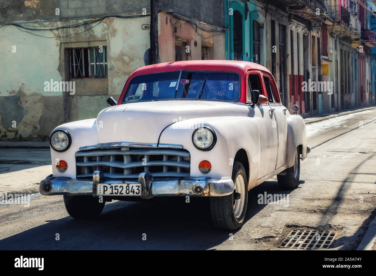 Street Scene with white and red Vintage Classic American Car, Havana, Cuba Stock Photo