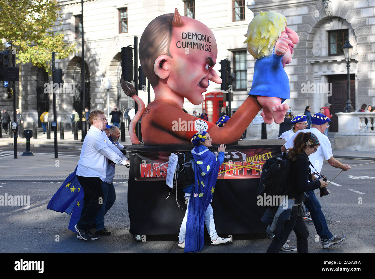 Protesters push a float depicting Dominic Cummings outside the Houses of Parliament in London after Prime Minister Boris Johnson delivered a statement in the House of Commons on his new Brexit deal on what has been dubbed 'Super Saturday'. Stock Photo