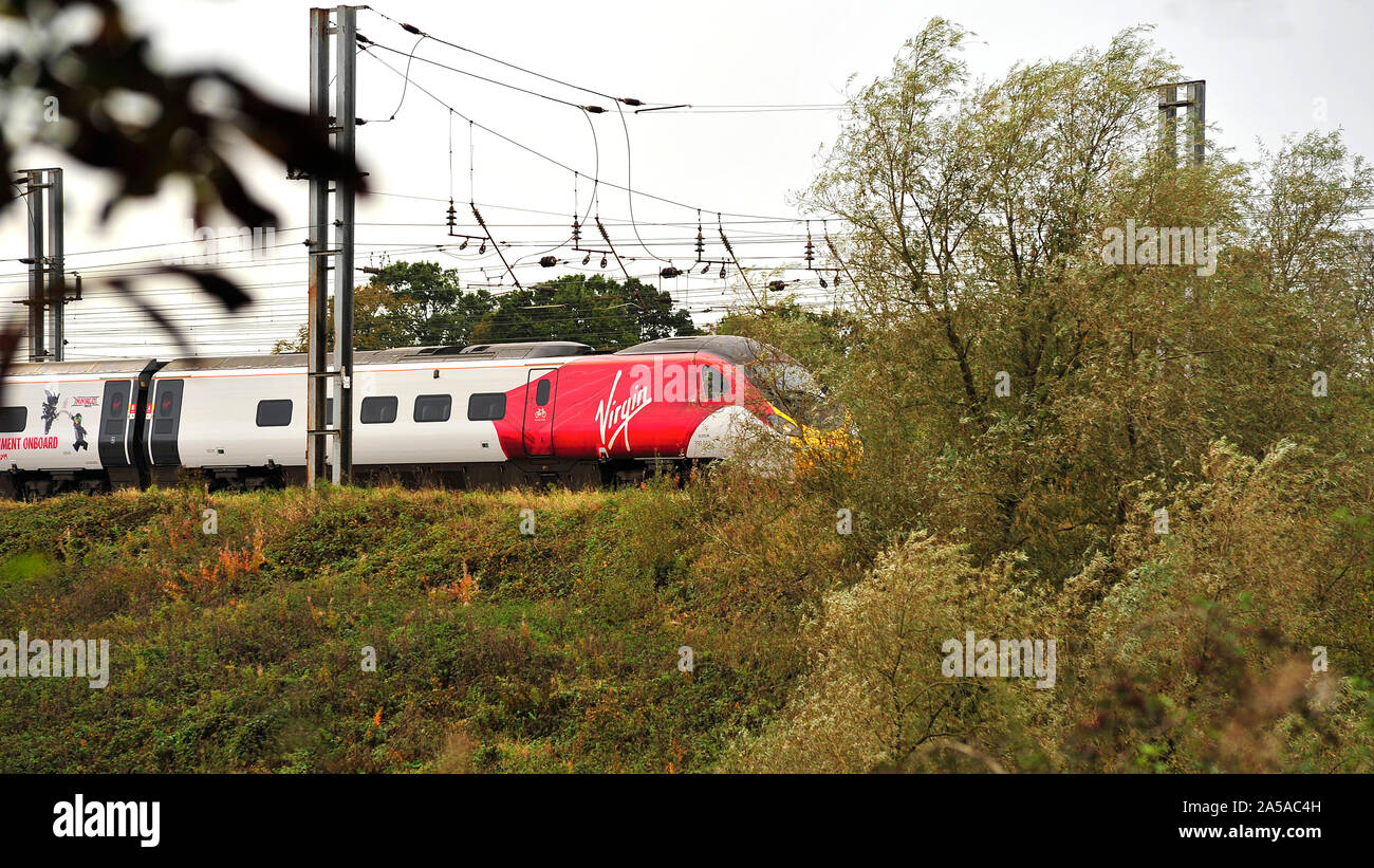 Virgin express train travelling through the Lancashire countryside toward Preston in autumn Stock Photo