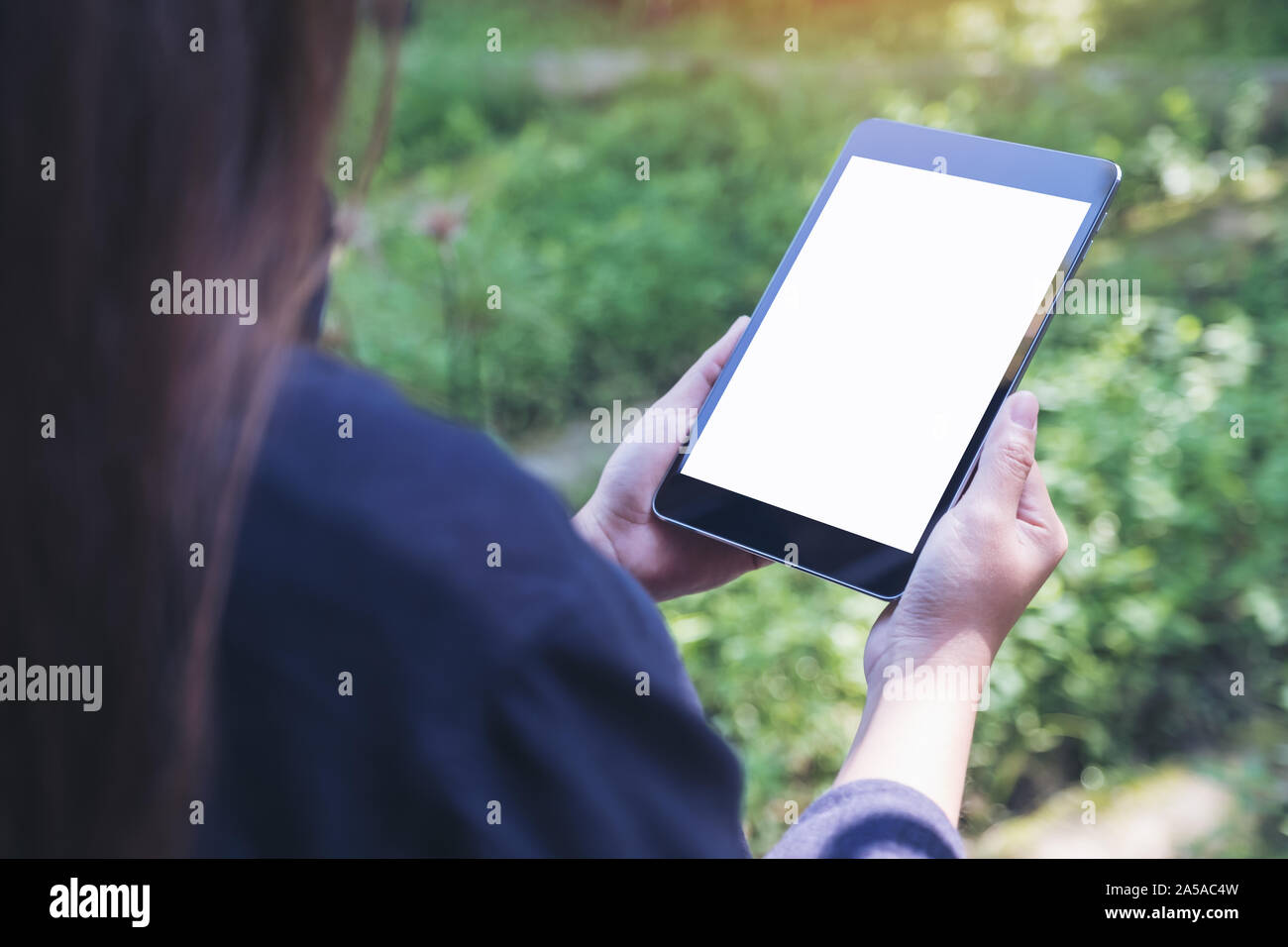 Mockup image of woman's hands holding black tablet pc with blank white ...
