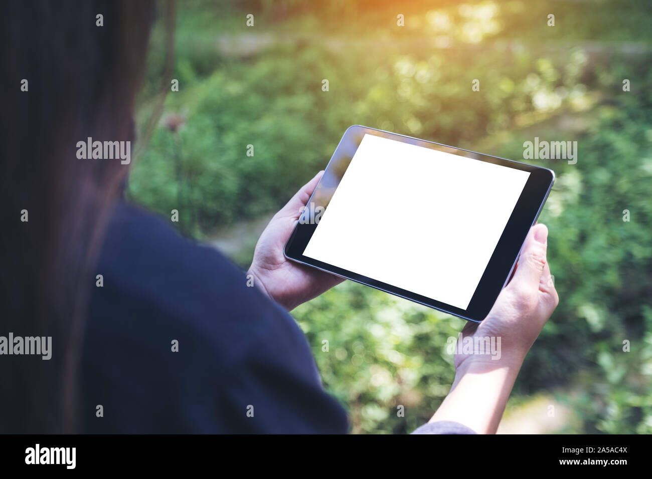 Mockup image of woman's hands holding black tablet pc with blank white ...