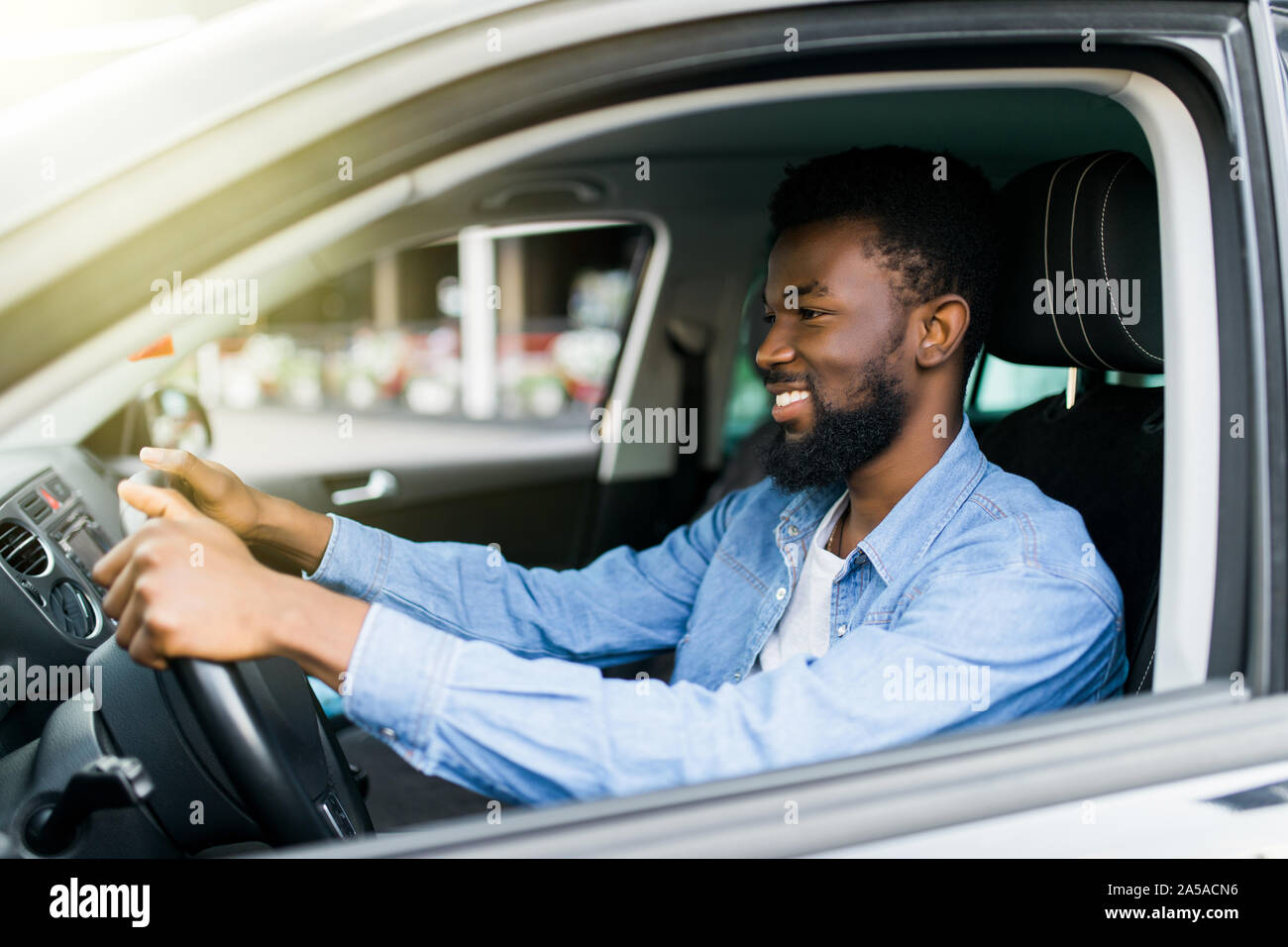 happy young african american man driving a car Stock Photo