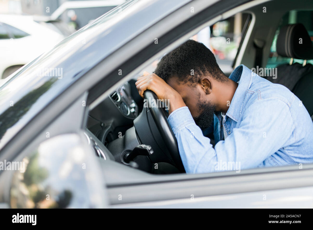 Tired young woman driver asleep on pillow on steering wheel, resting after  long hours driving a car. Fatigue. Sleep deprivation Stock Photo - Alamy