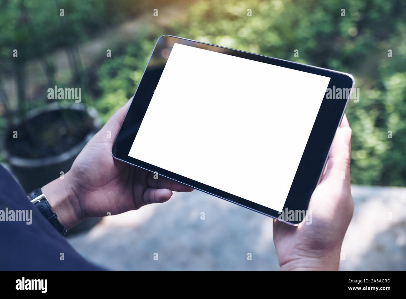 Mockup image of woman's hands holding black tablet pc with blank white ...