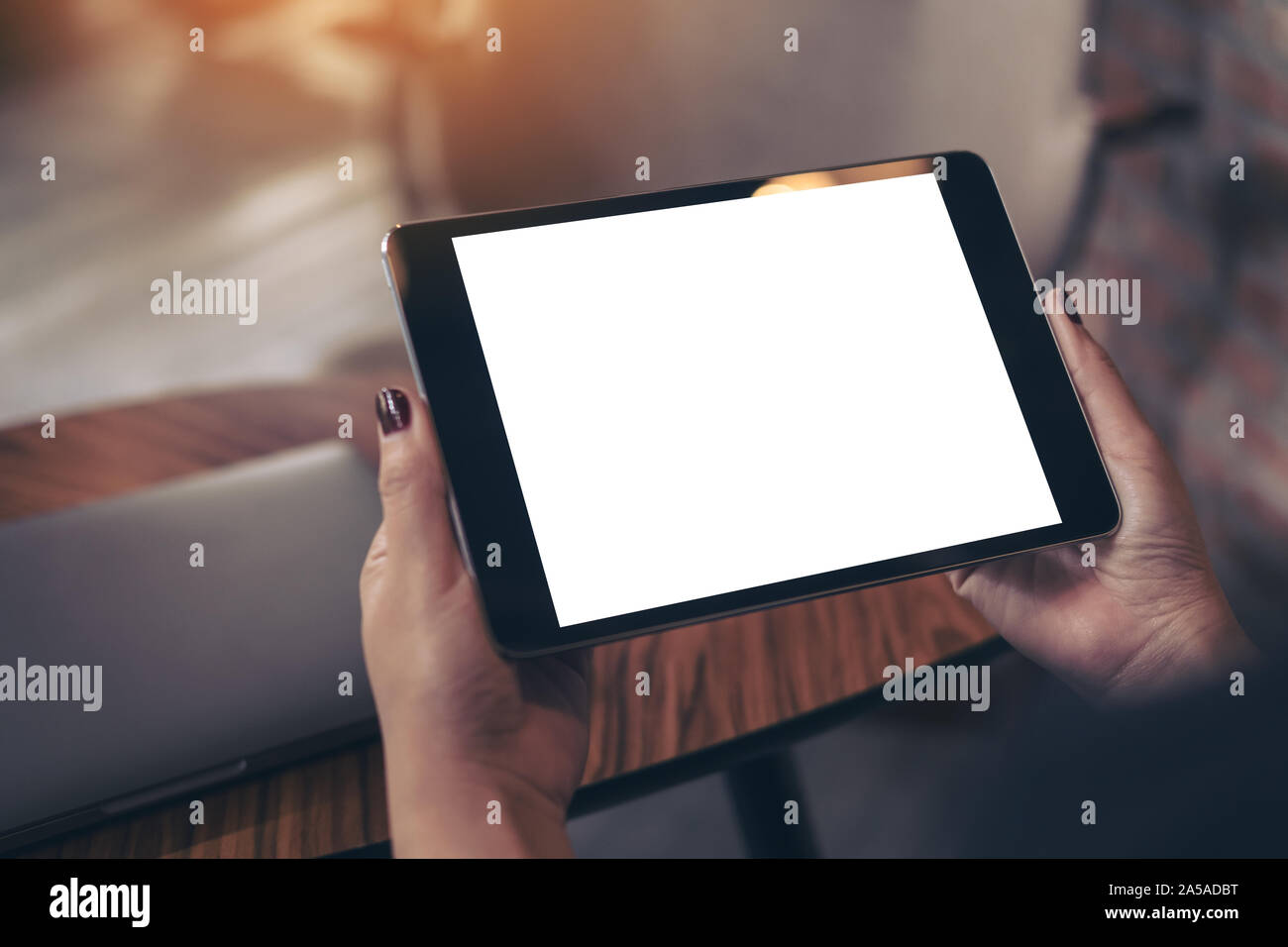 Mockup image of woman's hands holding black tablet pc with blank white ...
