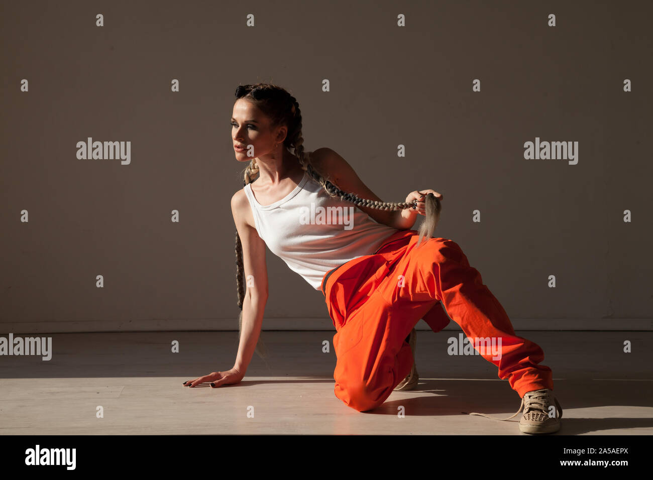 Portrait of a beautiful woman with braids dancing to music Stock Photo ...