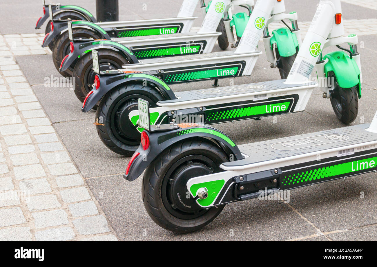 Side view of five model Lime-S electric scooter (E-Scooters) frames from Lime parked at the sidewalk of a street. Frankfurt am Main, Germany. Stock Photo