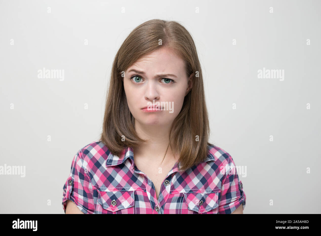 Young caucasian woman girl with questioning, puzzled, confused expression, thinking or remembering something Stock Photo