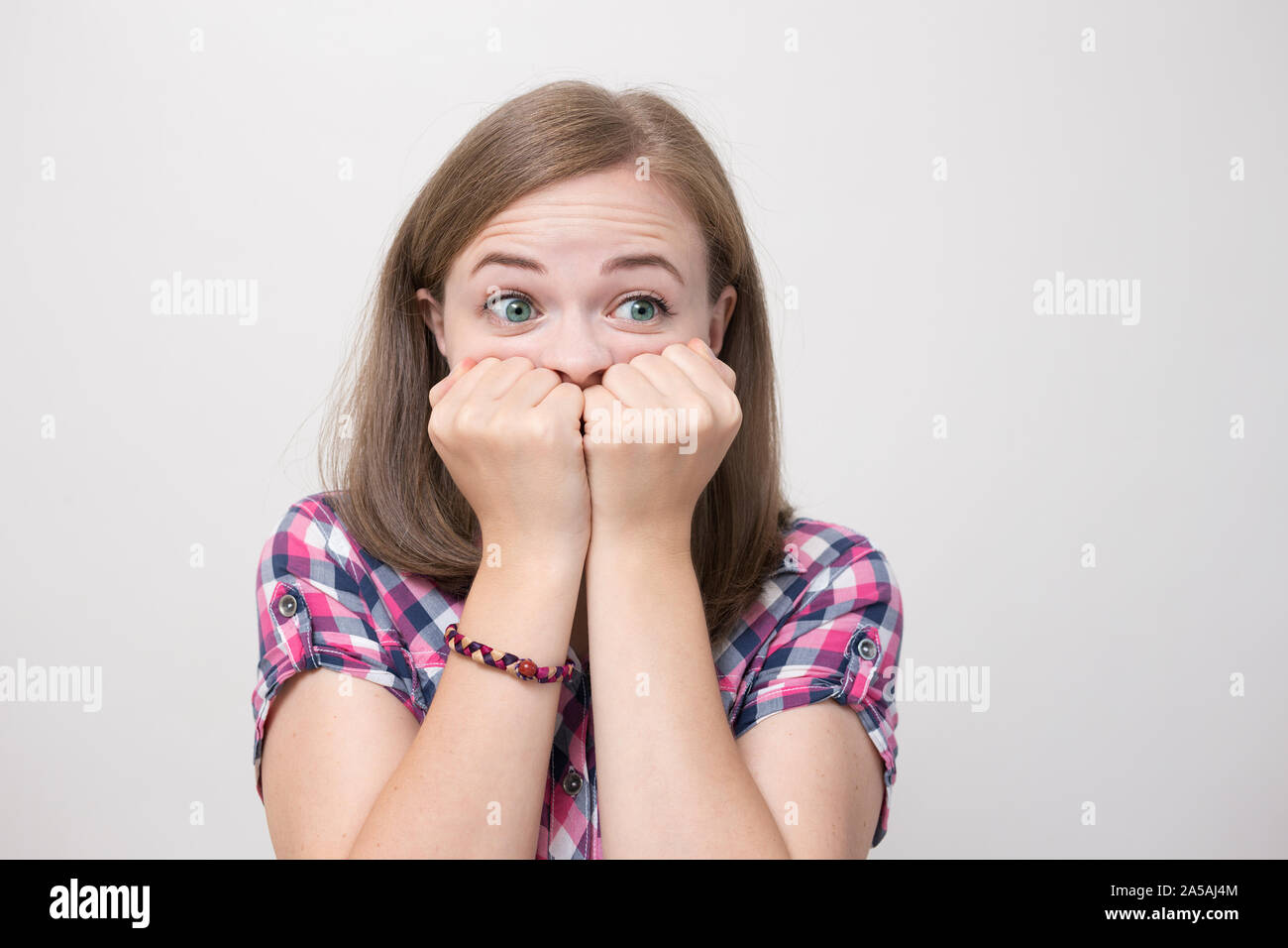Young caucasian woman girl surprised, scared, shocked, frightened Stock Photo