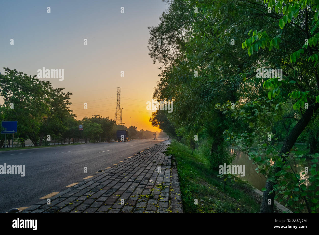Beautiful straight road at sunrise, Lahore Canal Pakistan Stock Photo