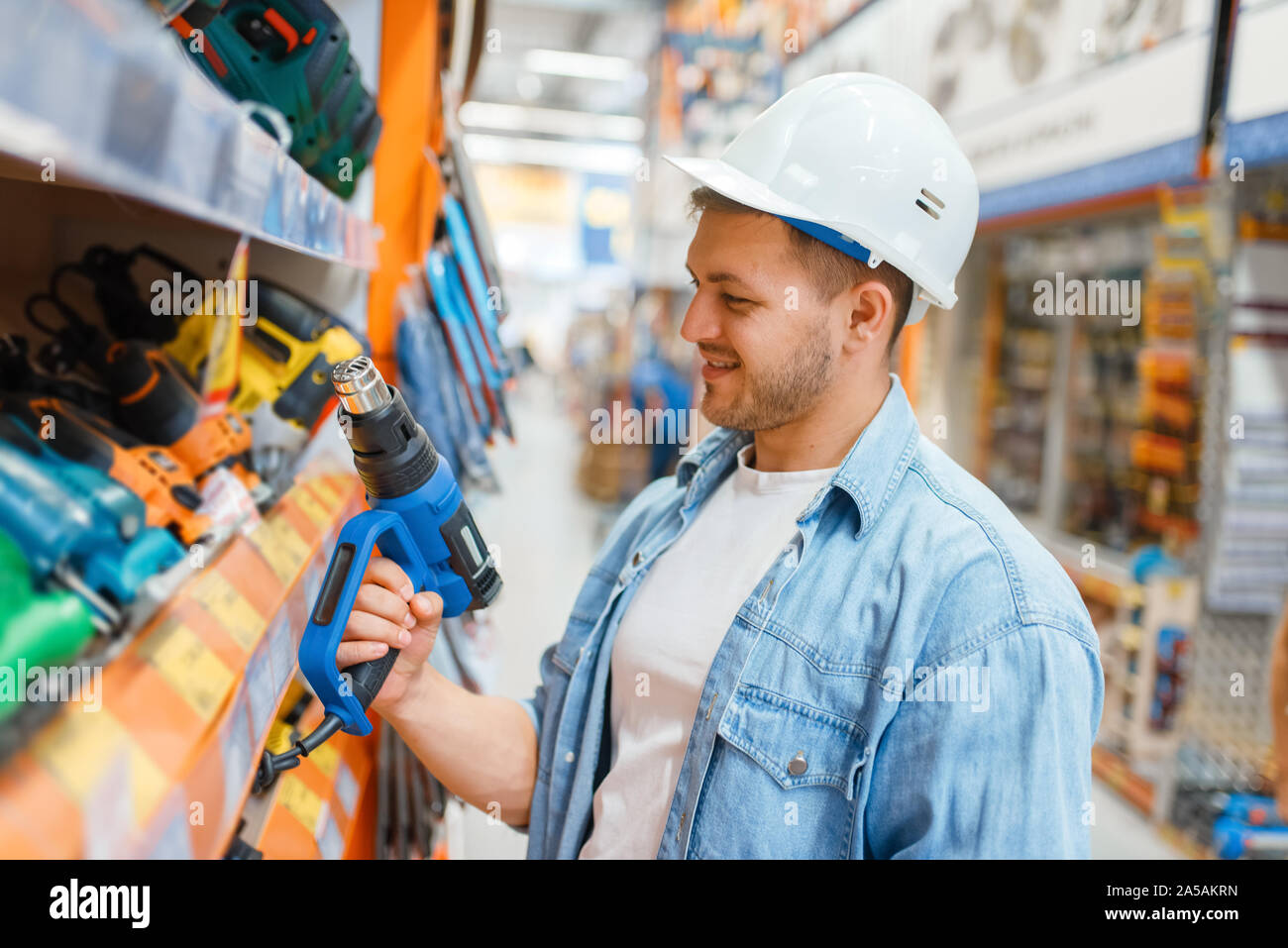 Male buyer choosing tools in hardware store Stock Photo Alamy