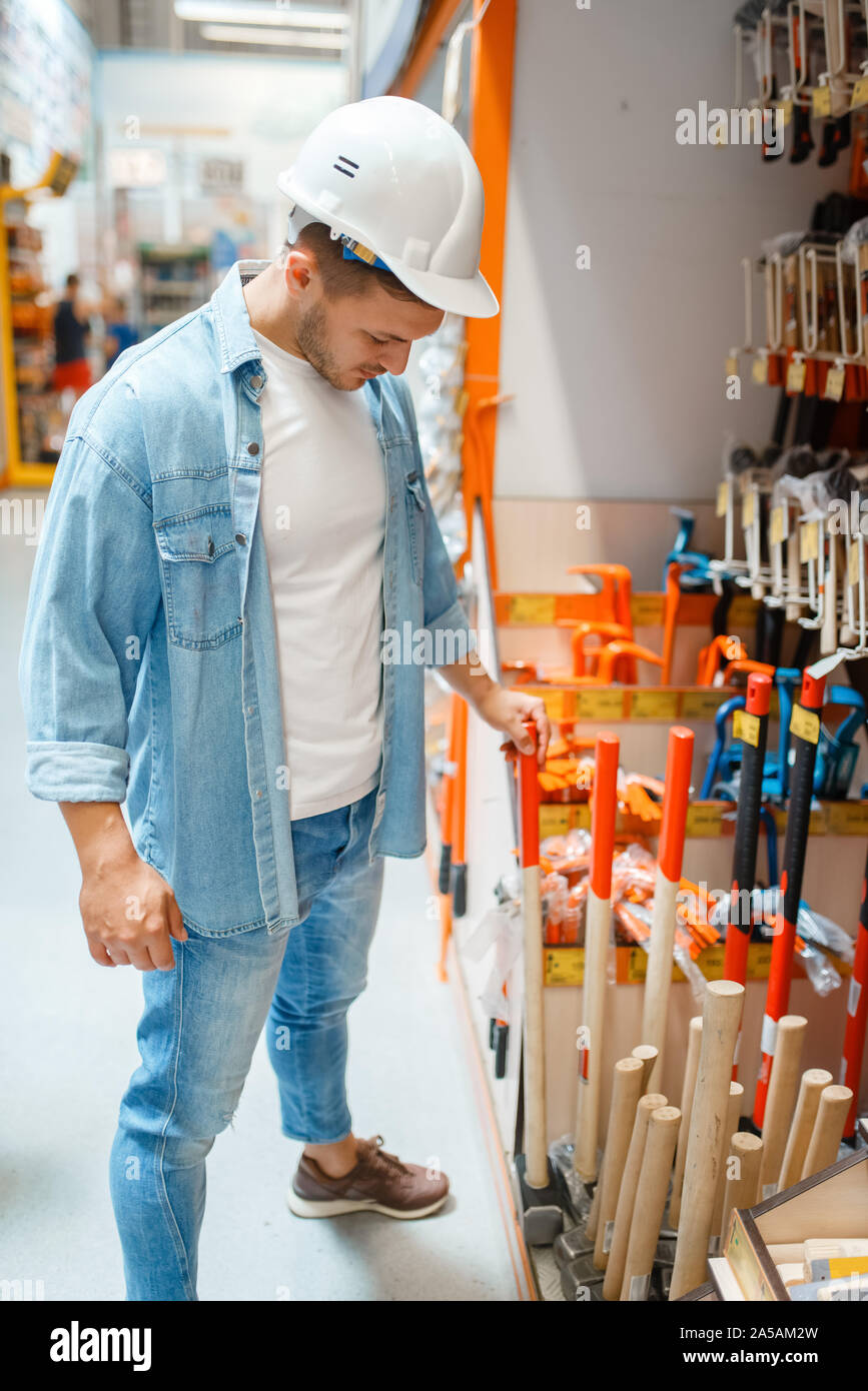 Male buyer choosing hammer in hardware store Stock Photo Alamy