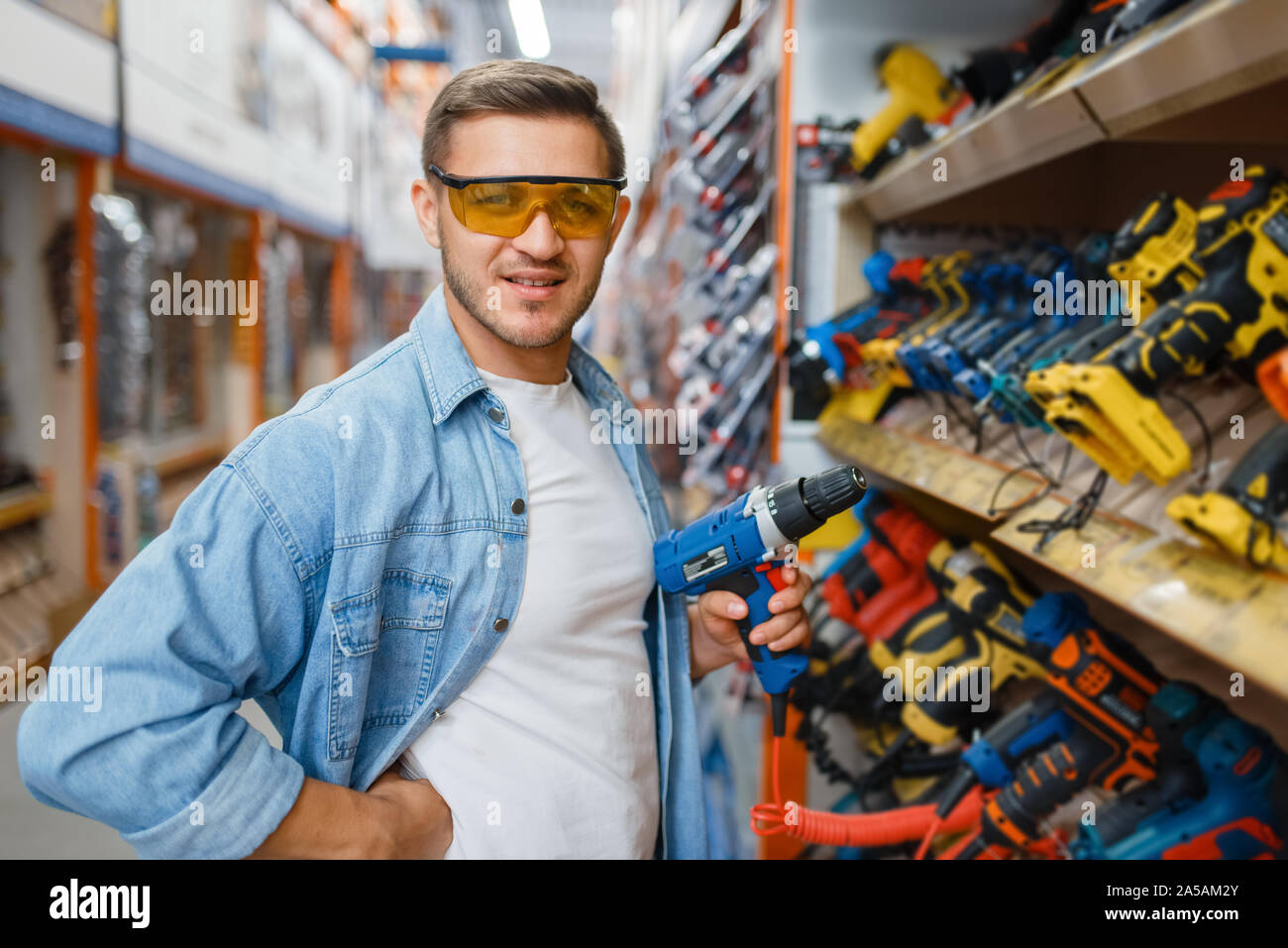 Buyer holding electric screwdriver, hardware store Stock Photo Alamy