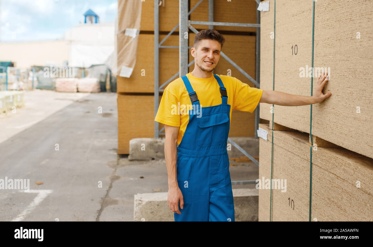 Builder at the chipboard palletes, hardware store Stock Photo