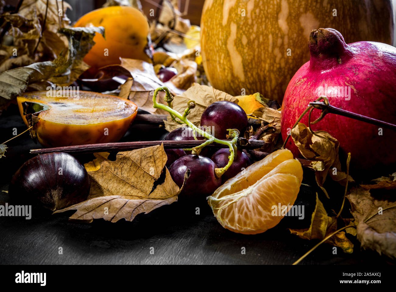 Autumnal background with dried leaves and various fruits Stock Photo ...