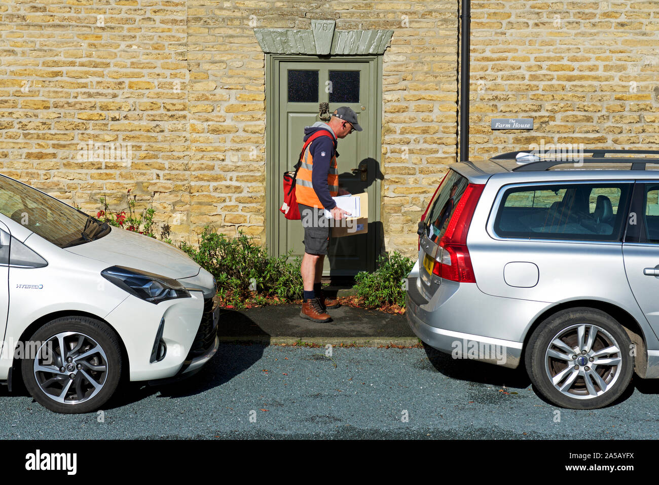 Postman Delivering Mail To House, England UK Stock Photo - Alamy